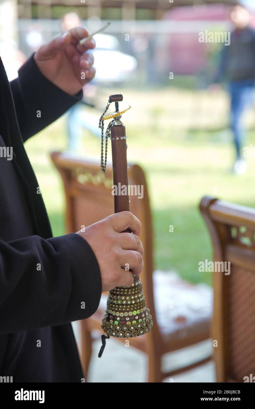 The man was holding a zurna in his hand . A man playing zurna
