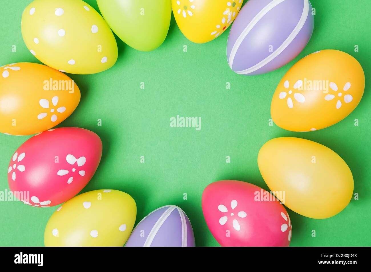 Colorful Easter eggs on white wooden table Stock Photo