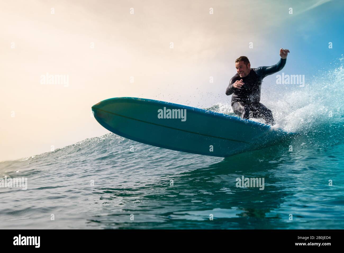Surfer riding waves on the island of fuerteventura Stock Photo