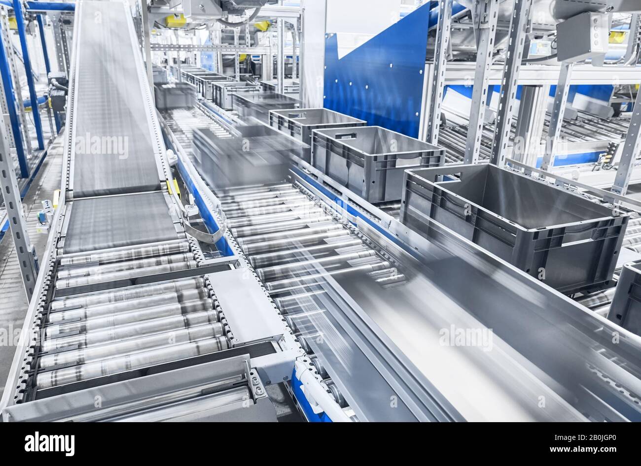 Modern conveyor system with boxes in motion, shallow depth of field. Stock Photo