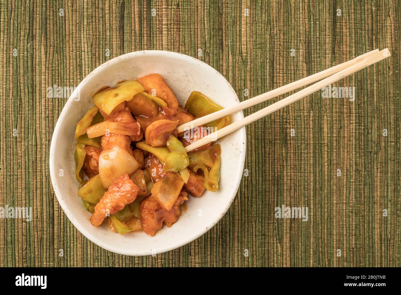 closeup bowl of sweet and sour chicken on a table Stock Photo