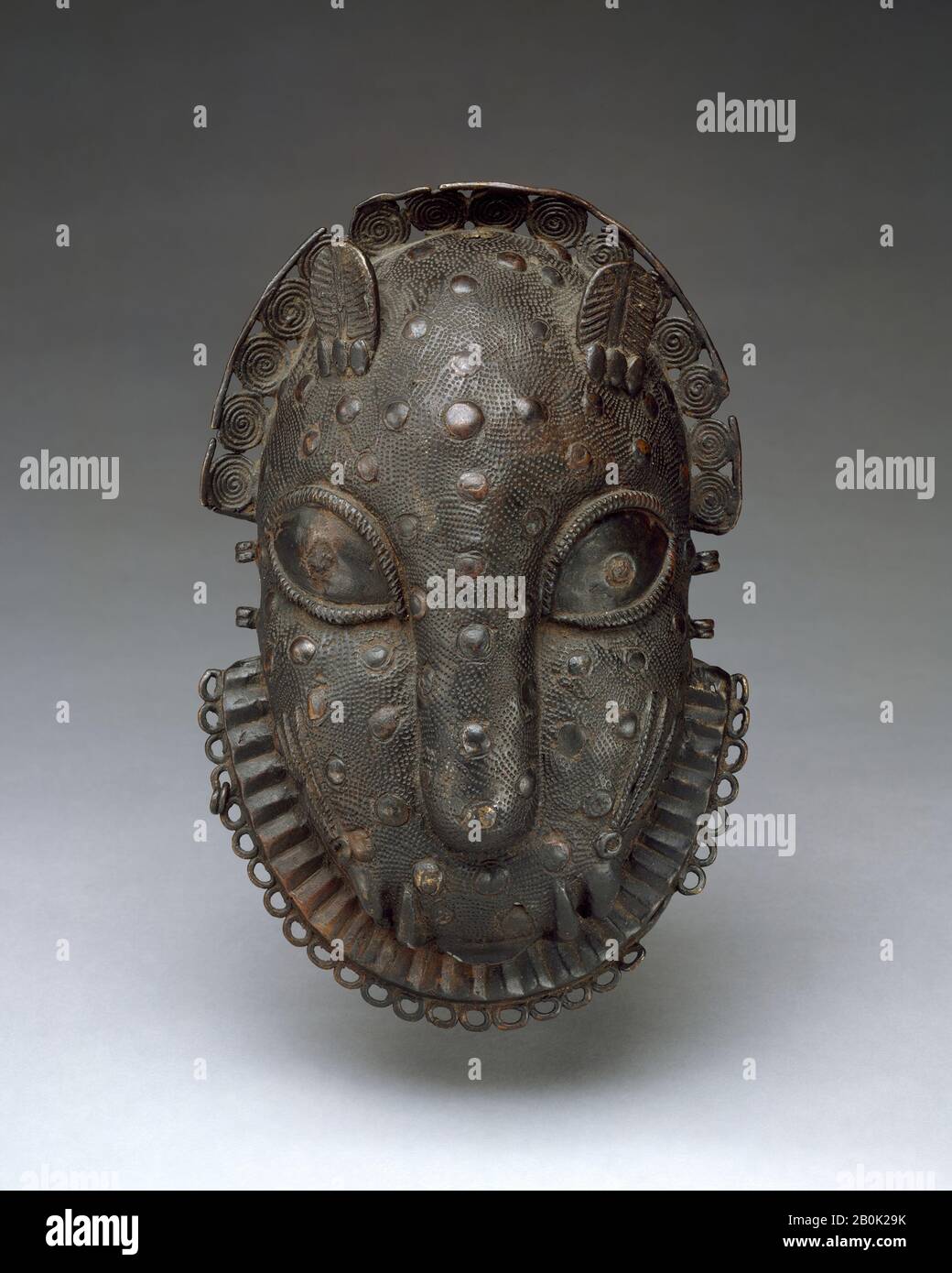 Hip Ornament: Leopard Head, Edo peoples, 16th–19th century, Nigeria, Court of Benin, Edo peoples, Brass, iron, H. 7 1/2 x W. 4 3/4 x D. 2 1/8 in. (19.1 x 12.1 x 5.4 cm), Metal-Ornaments Stock Photo