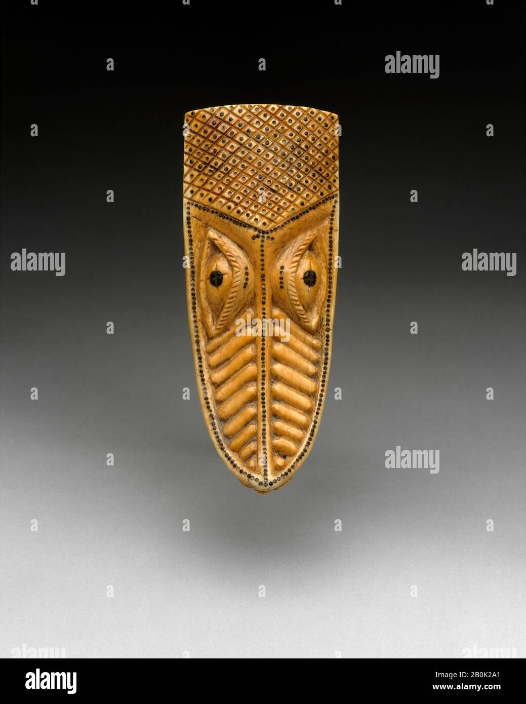 Masquerade Element: Crocodile Head (Omama), Yoruba peoples, Owo group, 17th–19th century, Nigeria, Yoruba peoples, Owo group, Ivory, wood or coconut shell inlay, H. 5 1/2 x W. 2 1/4 x D. 1 1/2in. (14 x 5.7 x 3.8cm), Bone/Ivory-Ornaments Stock Photo