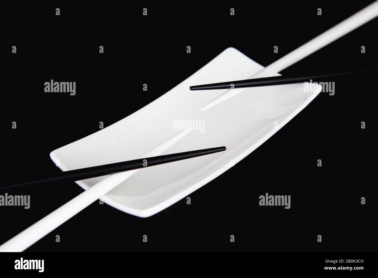White Empty Sushi Plates With Black and White Bamboo Chopsticks. Black