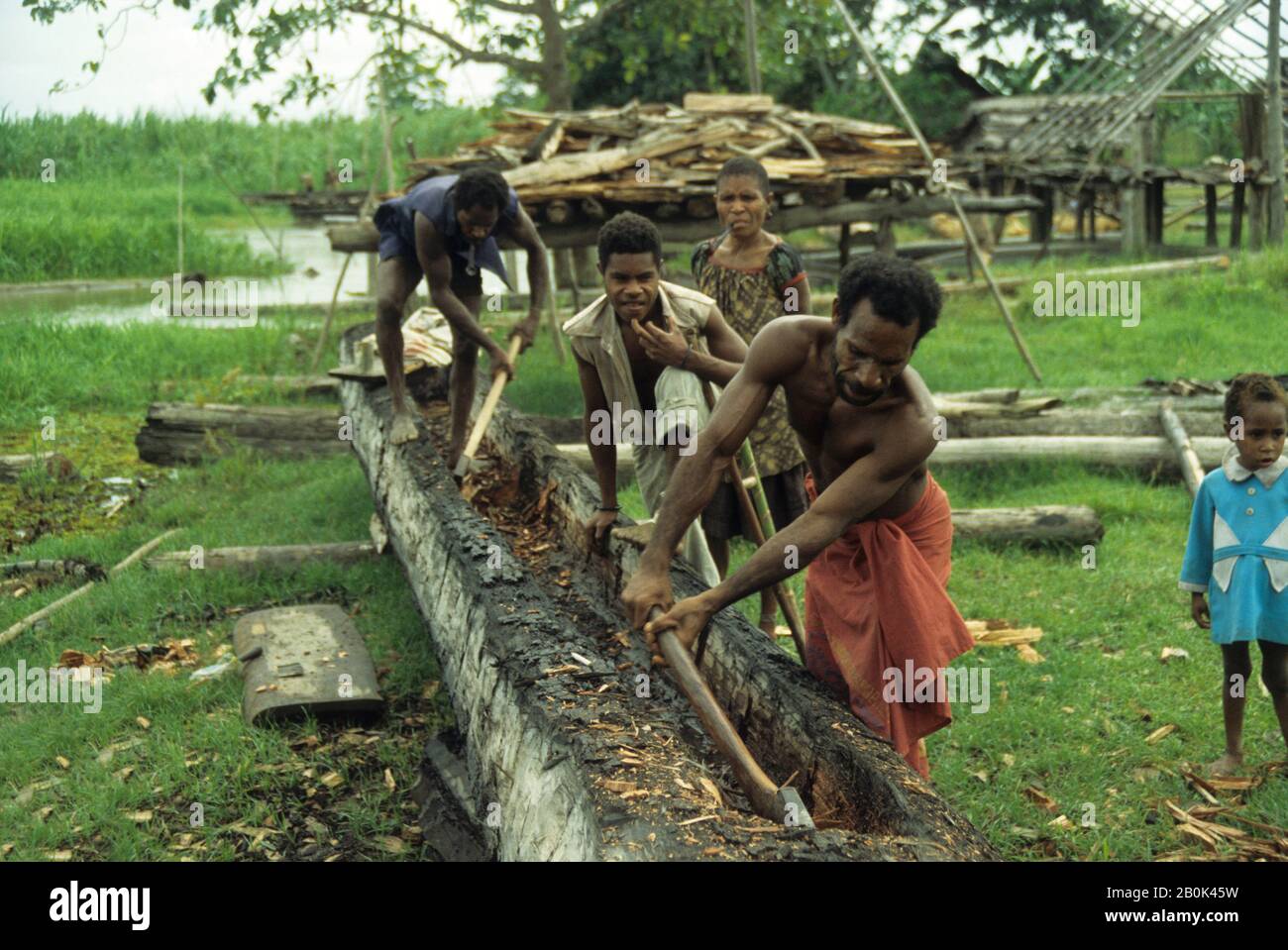 Papua New Guinea Sepik River Men Carving Dugout Canoe From Tree Trunk Stock Photo Alamy