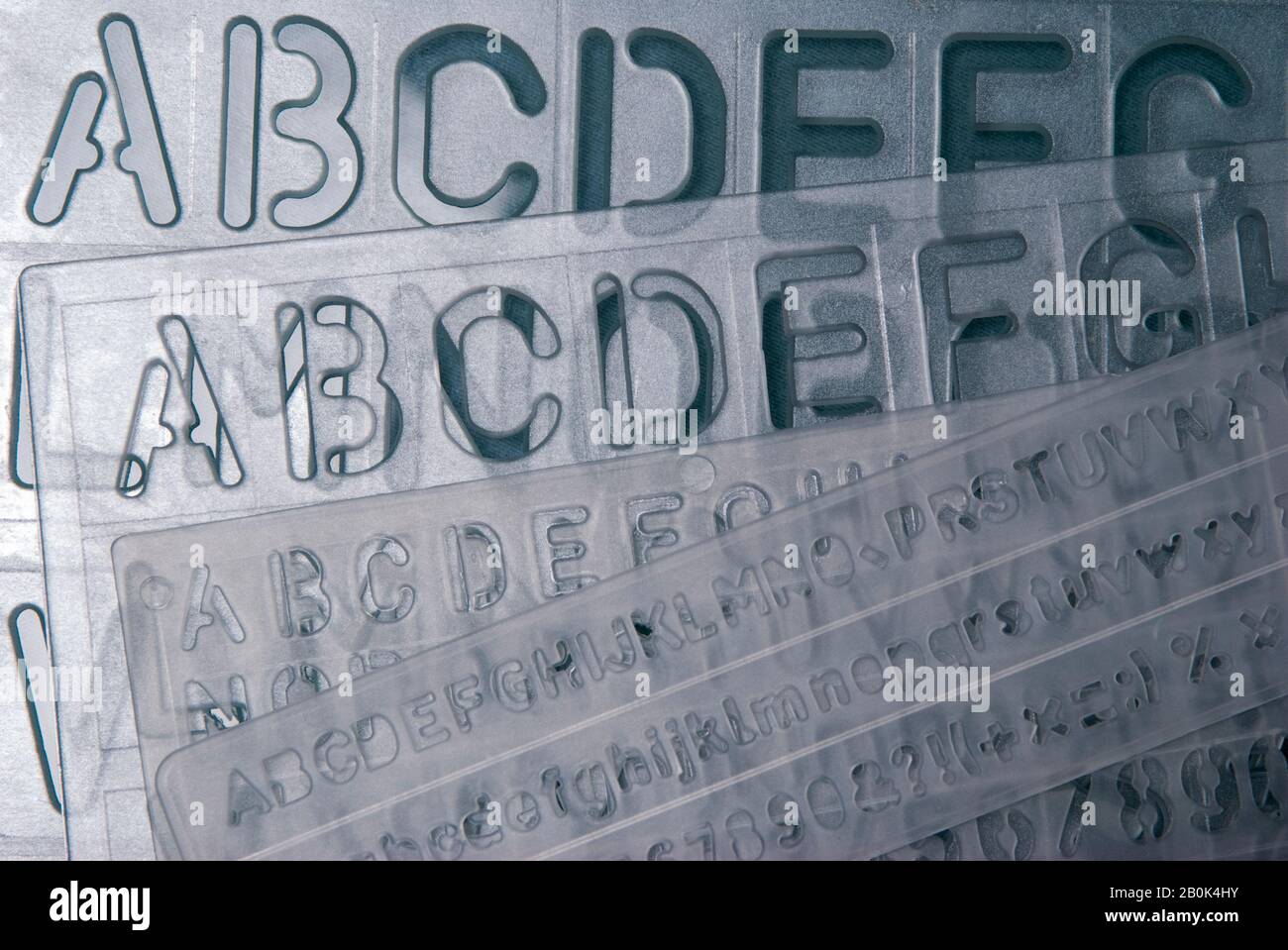 Clear plastic alphabet stencil sheets stacked on top of each other with  copy space Stock Photo - Alamy
