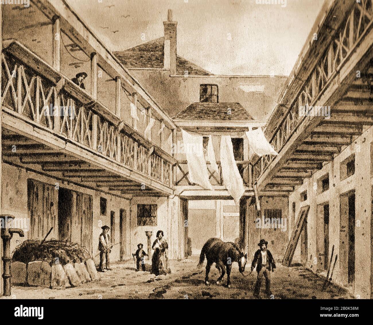 A very old engraving (or painting) showing the coach yard and stables at the King's Arms Tavern, (sometimes called the King's Head) 132  High Holborn, London, UK (Circa 1850). The image is interesting in that it shows the building 'warts and all' with washing hanging from the galleries and a groom, hay fork in hand standing next to a pile of recently gathered horse dung and straw. A water pump stands to the left. Stock Photo