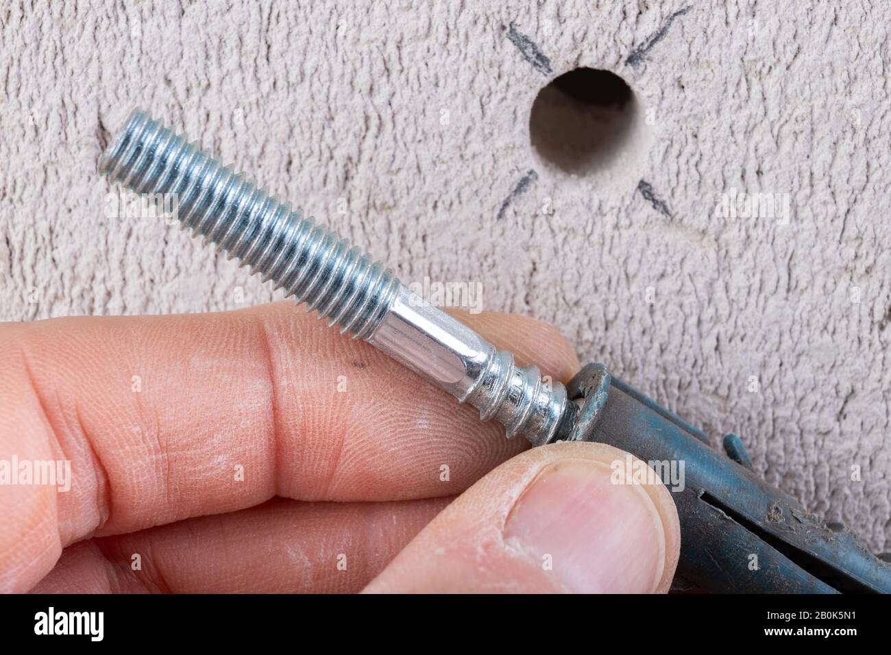 Hole in the wall, screw and dowel for fixing in concrete. Wall mounting