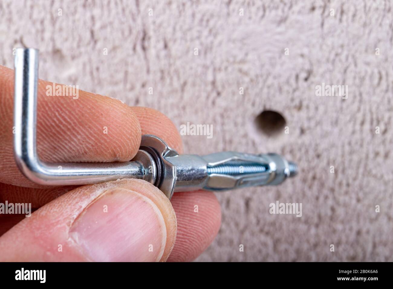 Hole in the wall, screw and dowel for fixing in concrete. Wall mounting