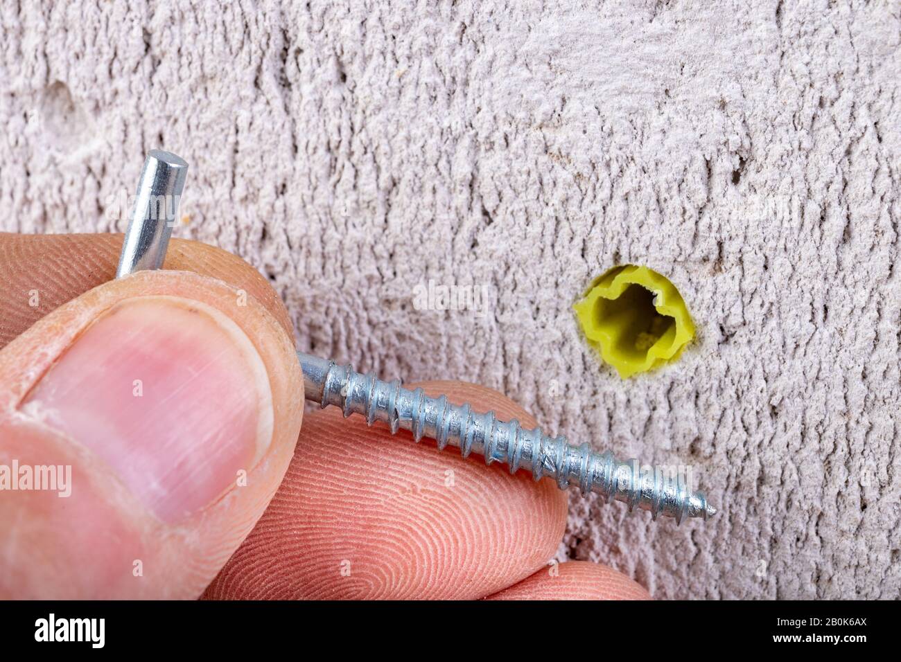 Hole in the wall, screw and dowel for fixing in concrete. Wall mounting