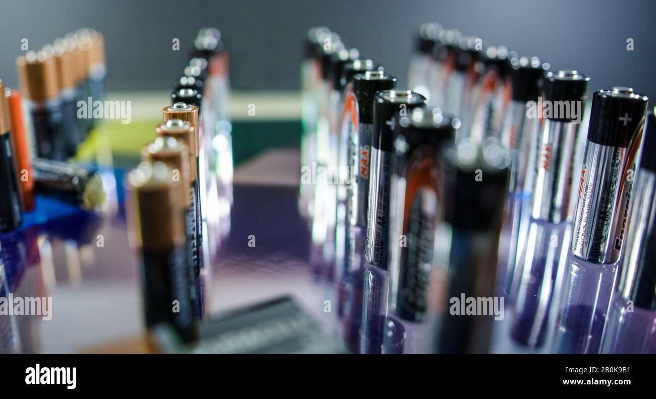 Rows of used AA batteries. Stock Photo