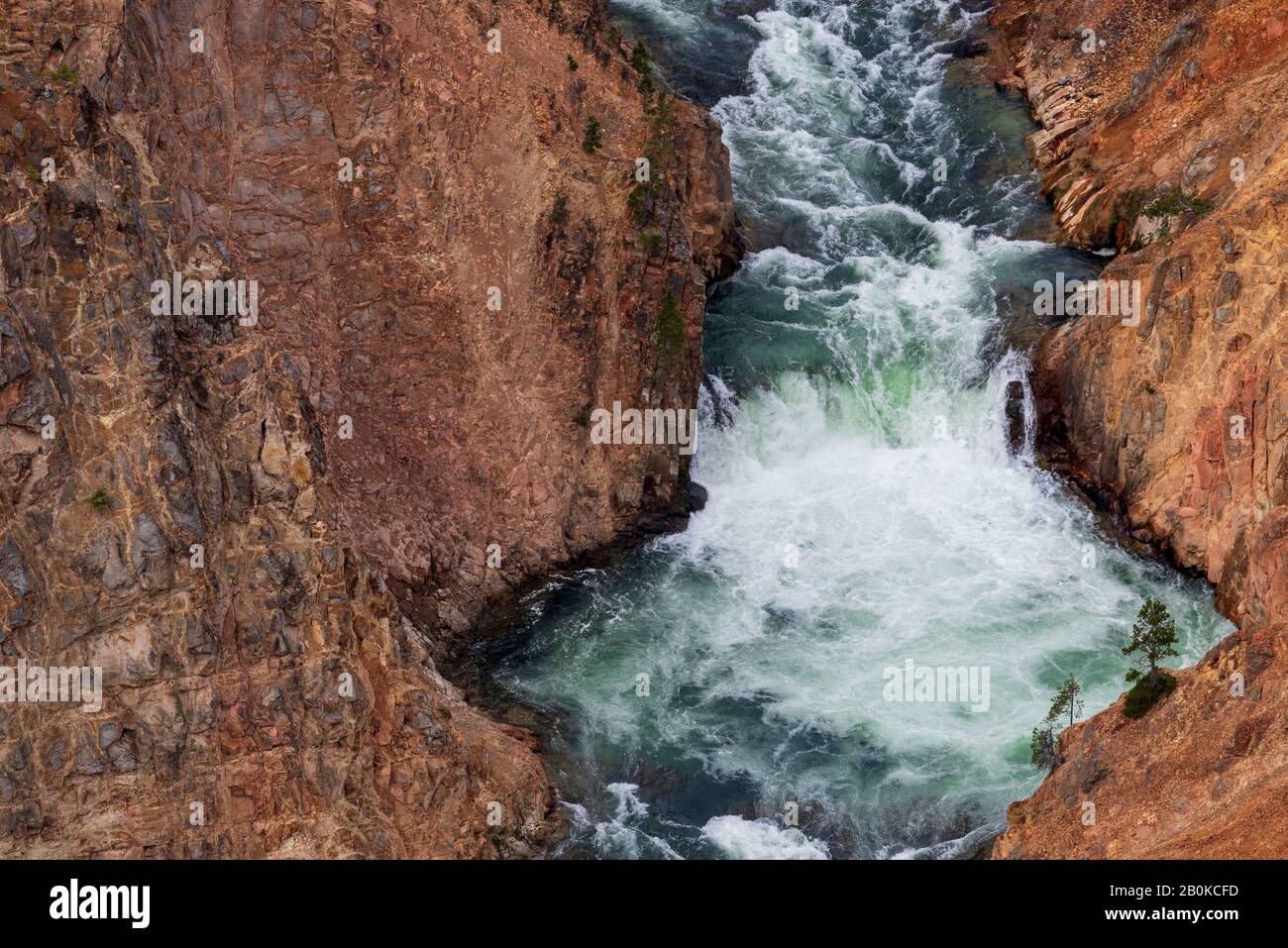 Rushing river water flowing down through steep canyon. Stock Photo