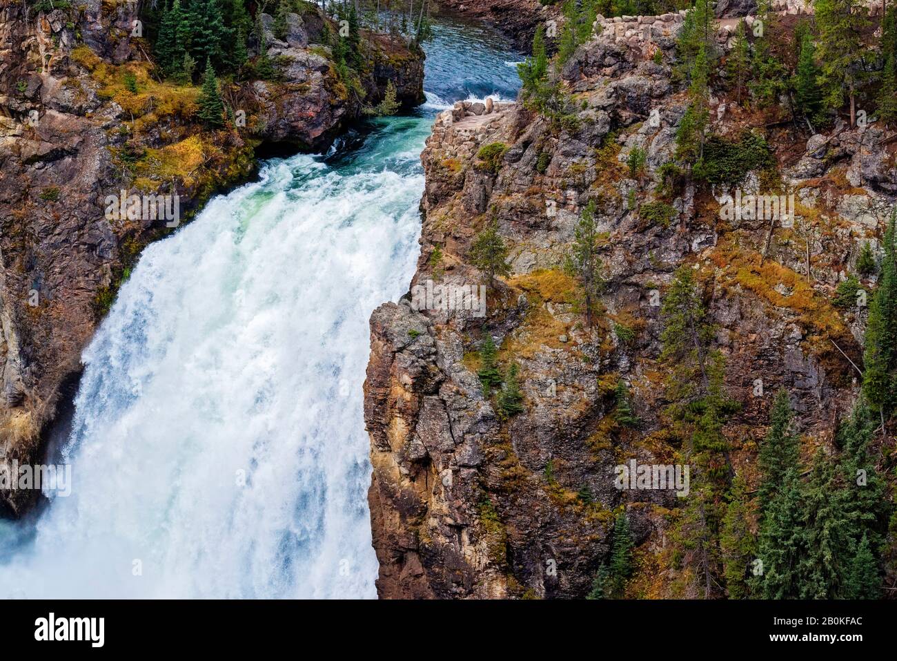 White Cliffs Water Rushing Fast moving white water rushing over cliff. Water fall with green trees ...