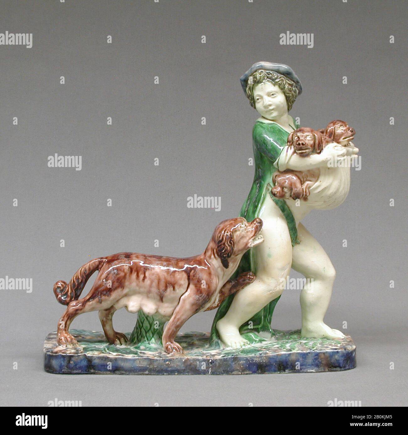 Boy carrying pups, French, Fontainebleau, ca. 1605–10, French, Fontainebleau, Lead-glazed earthenware, Overall: 9 15/16 × 10 1/2 × 4 9/16 in. (25.2 × 26.7 × 11.6 cm), Ceramics-Pottery Stock Photo