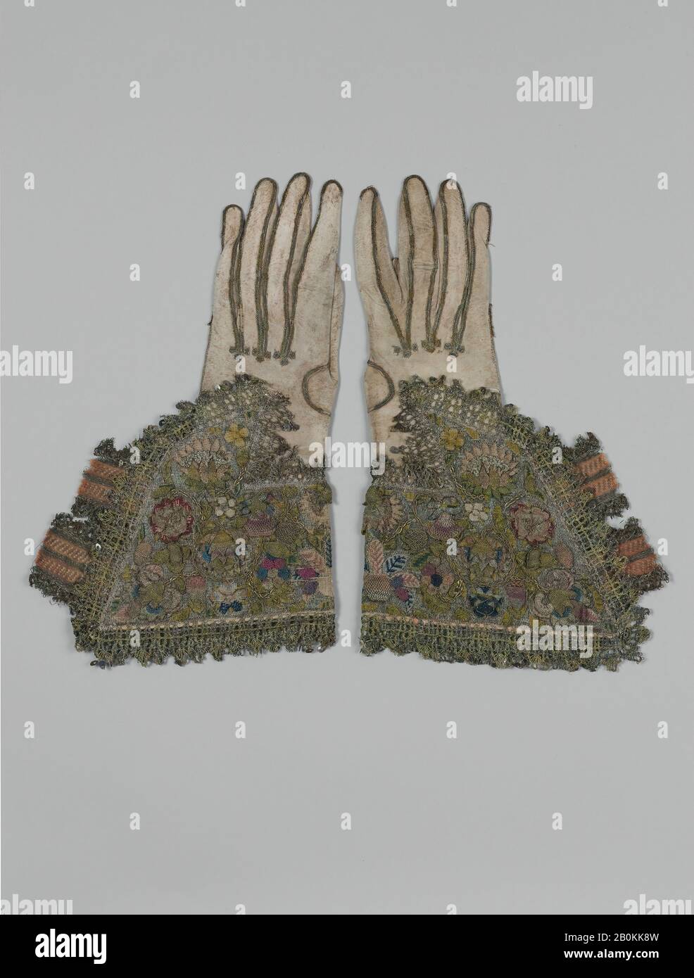 Pair of gloves, British, first half 17th century, British, Leather; canvas worked with silk and metal thread; tent, Gobelin, detached buttonhole variations, and plaited braid stitches; metal bobbin lace; silk and metal ribbon, L. 13 1/4 x W. 8 inches (33.7 x 20.3 cm), Textiles-Embroidered Stock Photo