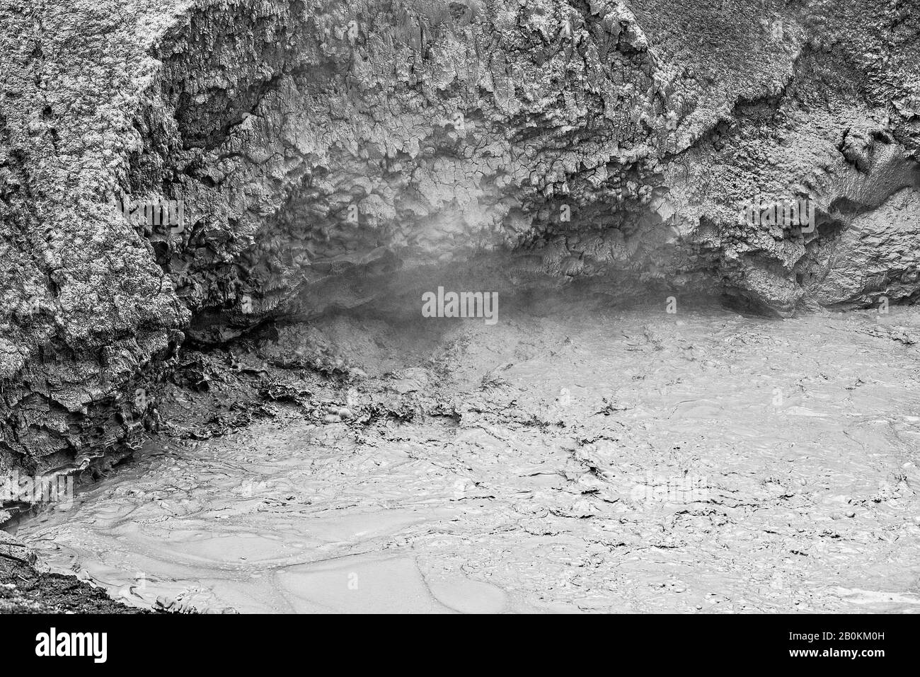 Mud pot spewing off hot gases and steam. Stock Photo