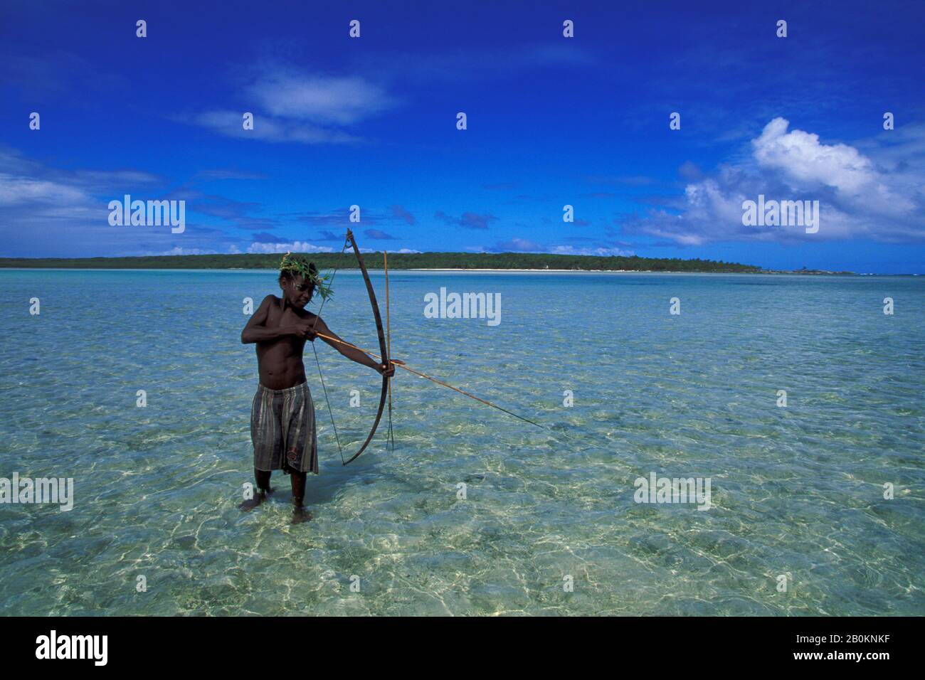 VANUATU, ANIWA ISLAND, TEENAGE BOY FISHING WITH BOW AND ARROW IN LAGOON  Stock Photo - Alamy