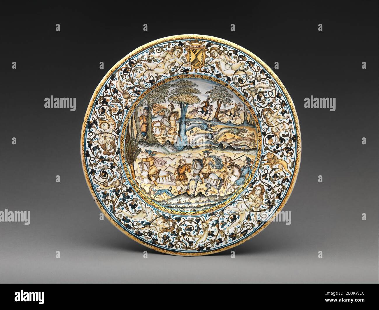 Francesco Grue, Plate with hunting scene and arms of the Alarçon y Mendoza family, Italian, Castelli, Francesco Grue (Italian, active Castelli, 1618–1673) or a close associate, ca. 1640–50, Italian, Castelli, Maiolica (tin-glazed earthenware), Overall: 1 11/16 × 12 7/16 in. (4.3 × 31.6 cm), Ceramics-Pottery Stock Photo
