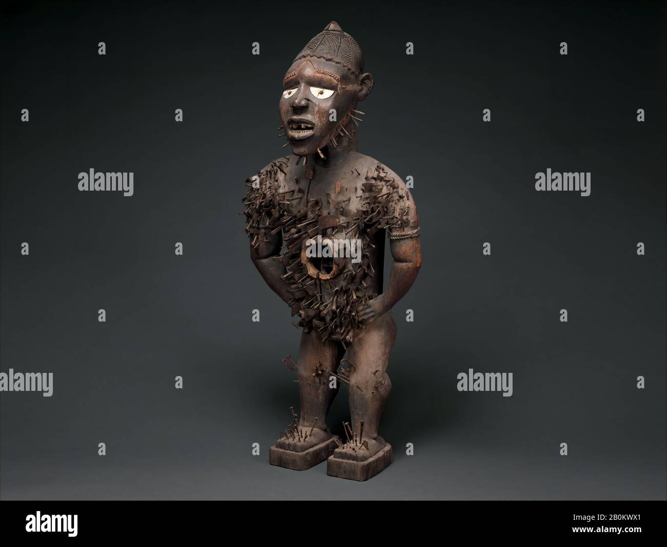 Power Figure (Nkisi N'Kondi: Mangaaka), Kongo peoples, Yombe group, 19th century, Republic of the Congo or Cabinda, Angola, Chiloango River region, Kongo peoples, Yombe group, Wood, iron, resin, ceramic, plant fiber, textile, pigment, H. 46 7/16 × W. 19 1/2 × D. 15 1/2 in., 53 lb. (118 × 49.5 × 39.4 cm, 24 kg), Wood-Sculpture Stock Photo