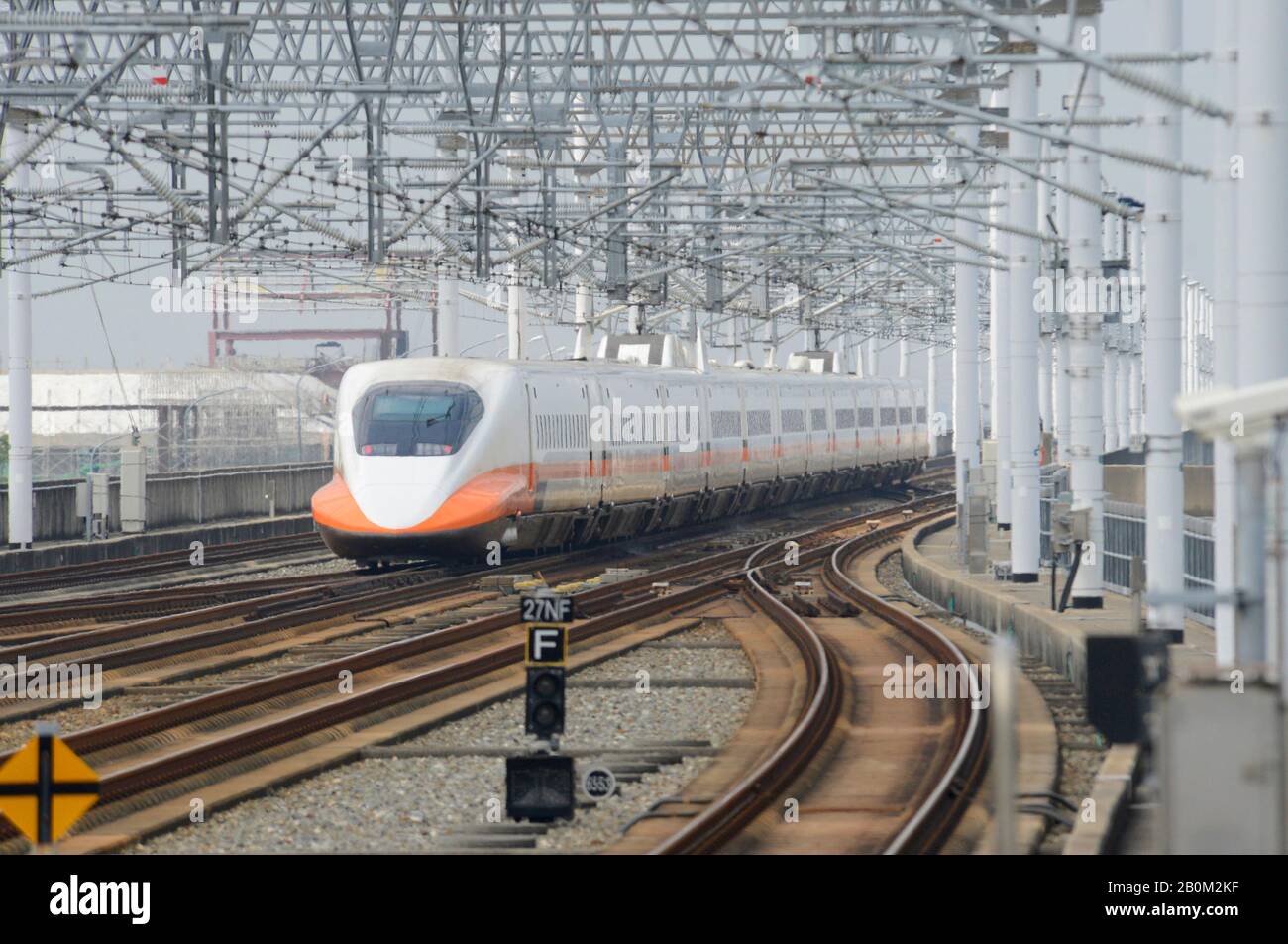 A High speed bullet train leaves Tainan HSR station, Taiwan Stock Photo