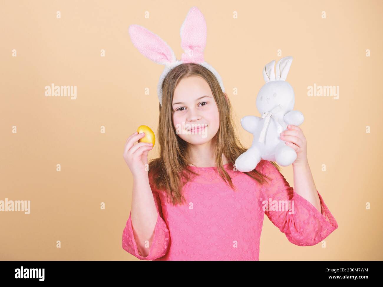 Easter symbols and traditions. Playful child with soft toy. Meet spring holiday. Easter egg