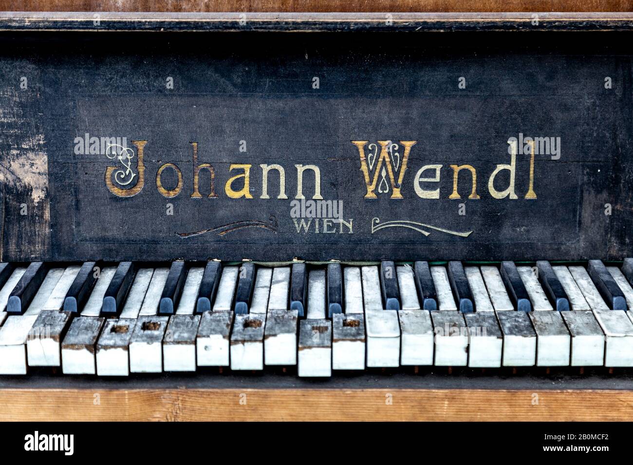Old abandoned broken Johann Wendl piano, damaged piano keys Stock Photo