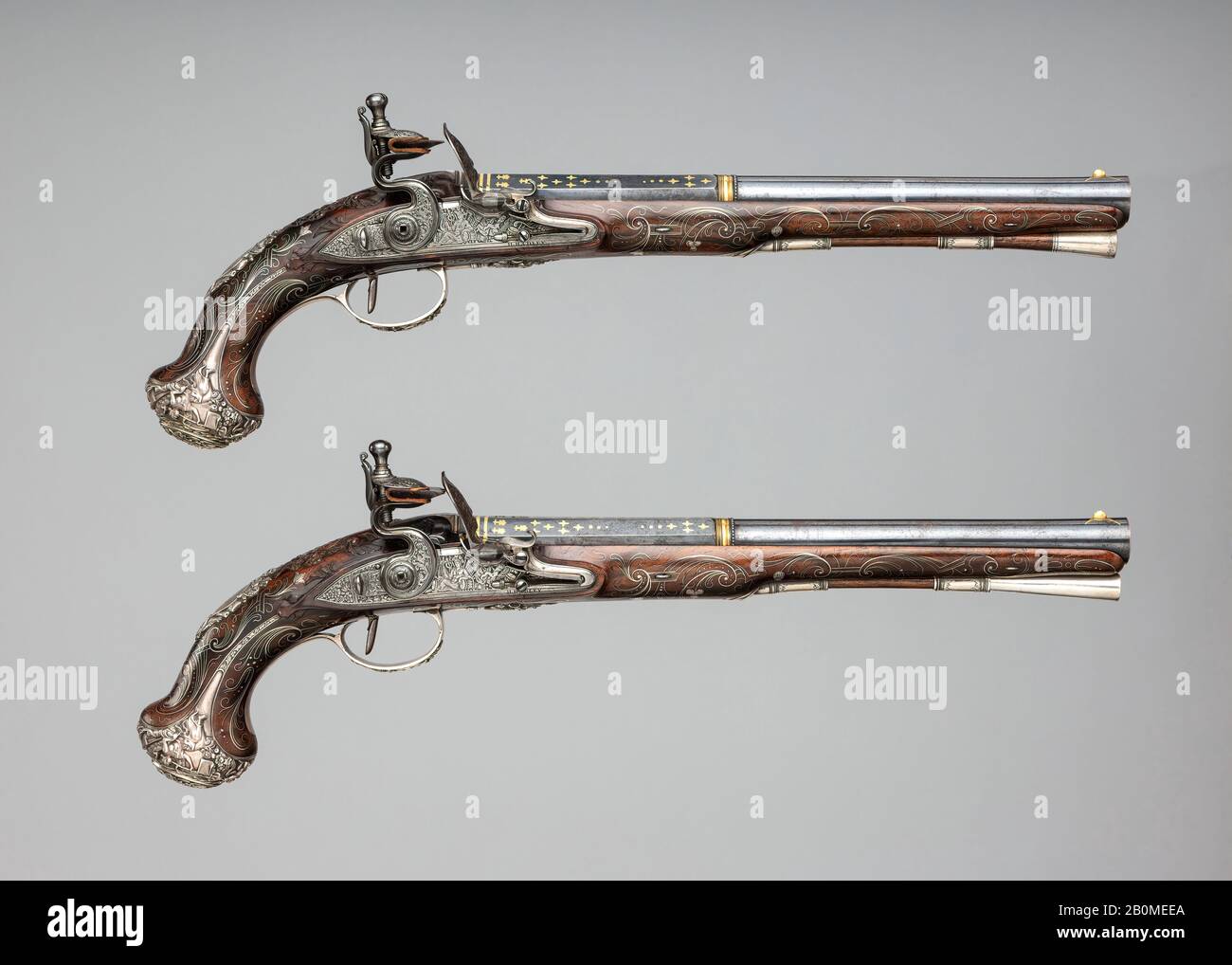 Henry Hadley, Pair of Flintlock Pistols with Square-Drive Key, British, London, ca. 1765, London, British, London, Steel, wood (walnut), silver, gold, copper alloy, Each pistol: L. 16 3/4 in. (42.5 cm); L. of barrel 11 1/4 in. (28.6 cm); Cal. .63 in. (16 mm); Wt. of pistol (a): 2 lb. 3.2 oz. (998 g); Wt. of pistol (b): 2 lb. 3.7 oz. (1012 g); drive key (c): H. 2 3/8 in. (6.03 cm); L. 1 9/16 in. (3.97 cm); Wt. 0.8 oz. (21 g), Firearms-Pistols-Flintlock Stock Photo