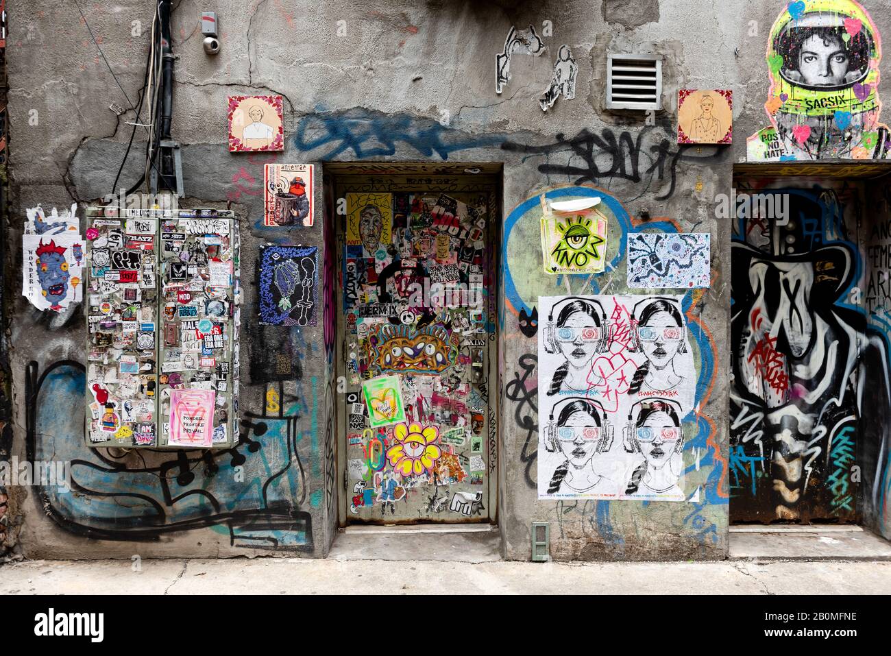 Graffiti covers an otherwise dull, gray wall in an alley on the Lower East Side, New York. Stock Photo