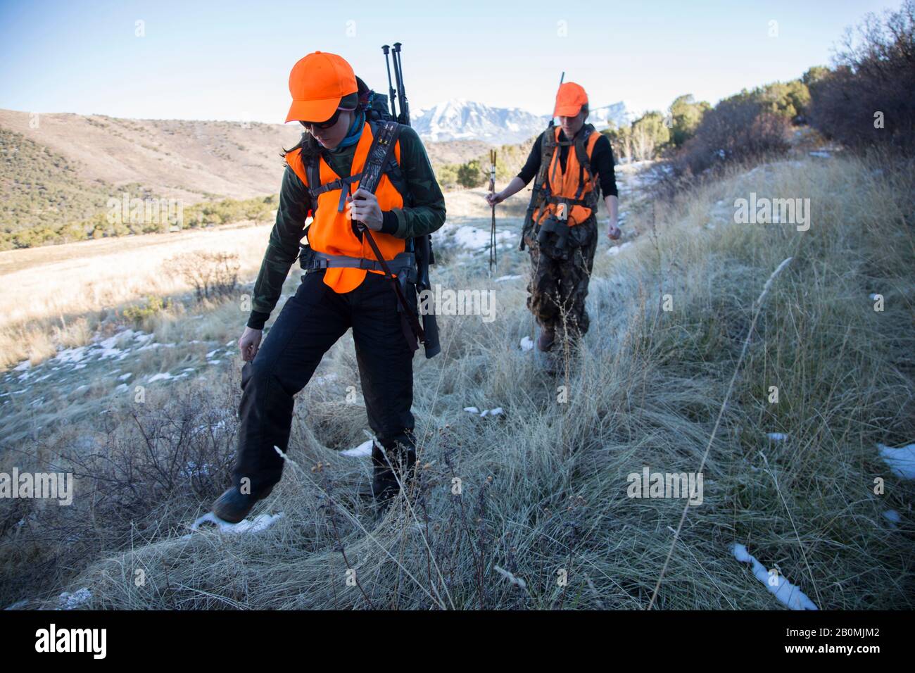 Two female hunters hike in the morning to hunt elk in Colorado Stock Photo