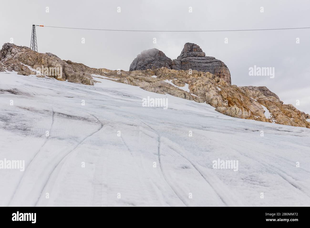 alpine mountain views strewn with snow under a blue sky Stock Photo