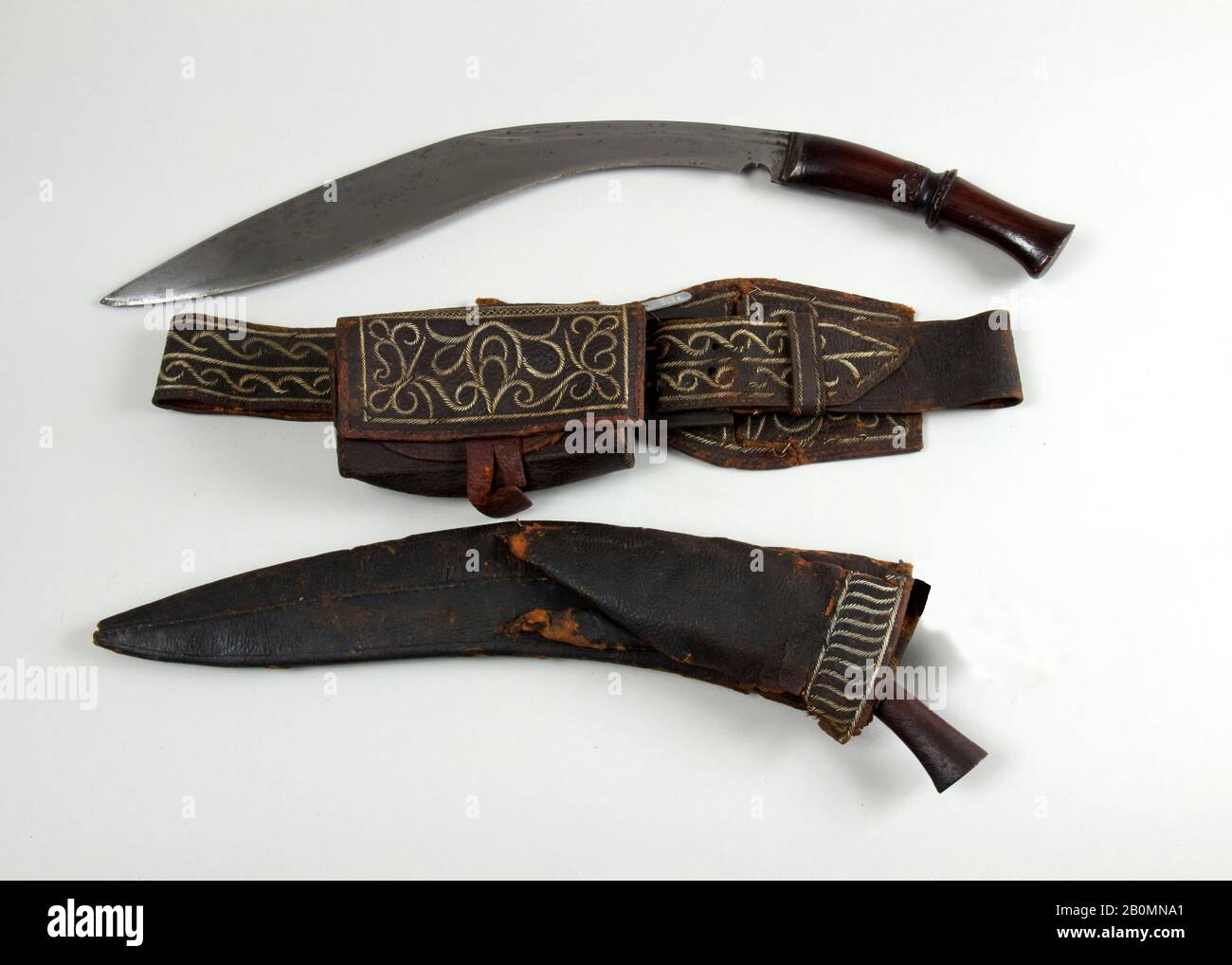Knife (Kukri) with Sheath, Small Knife, Belt, Pouch and Box, Indian or Nepalese, 19th century, Indian or Nepalese, Steel, wood, leather, quill, H. with sheath 18 1/4 in. (46.4 cm); H. without sheath 18 in. (45.7 cm); W. 2 1/2 in. (6.4 cm); Wt. 1 lb. 0.6 oz. (470.6 g); Wt. of sheath 4.3 oz. (121.9 g); small knife (c); H. 6 1/2 in. (16.5 cm); W. 1 1/2 in. (3.8 cm); Wt. 1.4 oz. (39.7 g); pouch (d); L. 6 1/4 in. (15.9 cm); Wt. 0.6 oz. (17 g); belt (e); L. 37 in. (94.0 cm); Wt. 5.2 oz. (147.4 g); loop (f); L. 10 1/2 in. (26.7 cm); Wt. 1.5 oz. (42.5 g); box (g); H. 3 in. (7.6 cm); W. 5 in. (12.7 cm Stock Photo