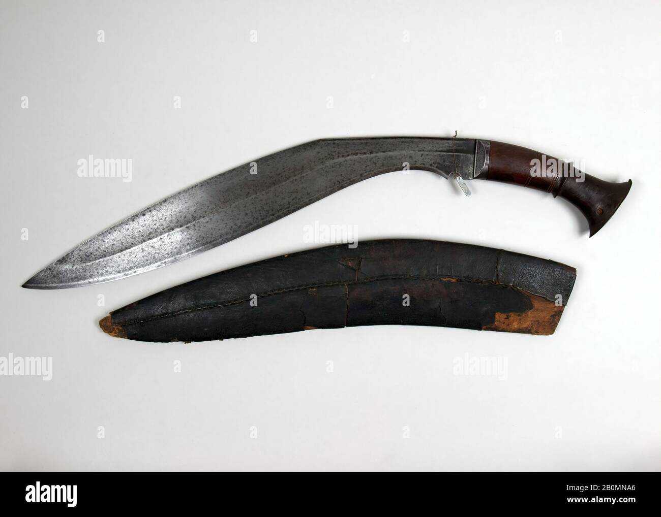 Knife (Kukri) with Sheath, Nepalese, 18th–19th century, Nepalese, Wood, H. with sheath 28 1/4 in. (71.4 cm); H. without sheath 28 in. (71.1 cm); H. of blade 22 in. (55.9 cm); W. 3 1/2 in. (8.9 cm); Wt. 3 lb. 2.8 oz. (1440.2 g); Wt. of sheath 9.6 oz. (272.2 g), Knives Stock Photo