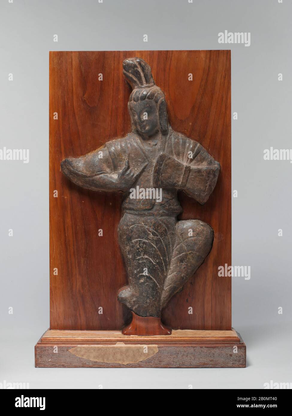 Musician Playing a Drum, China, Northern Wei dynasty (386–534), Date early 6th century, China, Limestone, H. 14 1/4 in. (36.2 cm); W. 9 in. (22.9 cm); D. 2 in. (5.1 cm), Sculpture Stock Photo