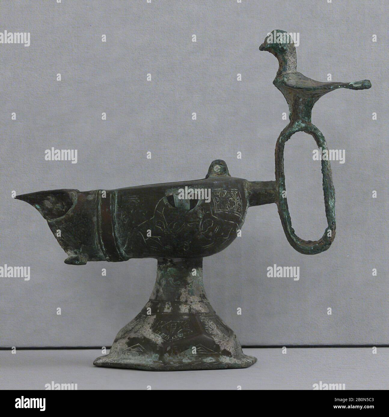 Oil Lamp, Oil lamp, 13th century, Attributed to Iran, Bronze, H. 6 1/4 in. (15.9 cm), W. 6 11/16 in. (17 cm), D. 3 3/16 in. (8.1 cm), Wt. 14.5 oz. (411.1 g), Metal Stock Photo