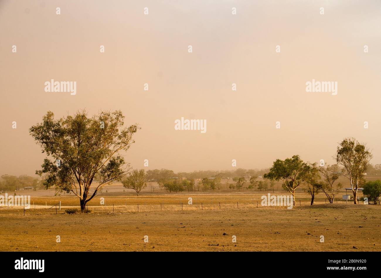 Drought and bush fire smoke on farm land Australia. Stock Photo