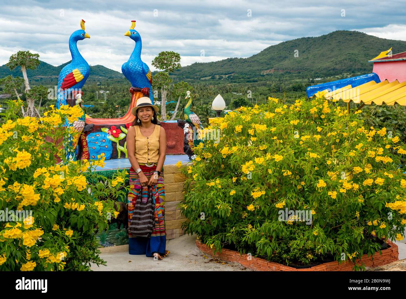 Pran Woman Woman standing in garden in wat in Pak Nam pran surrounded by flowers ...