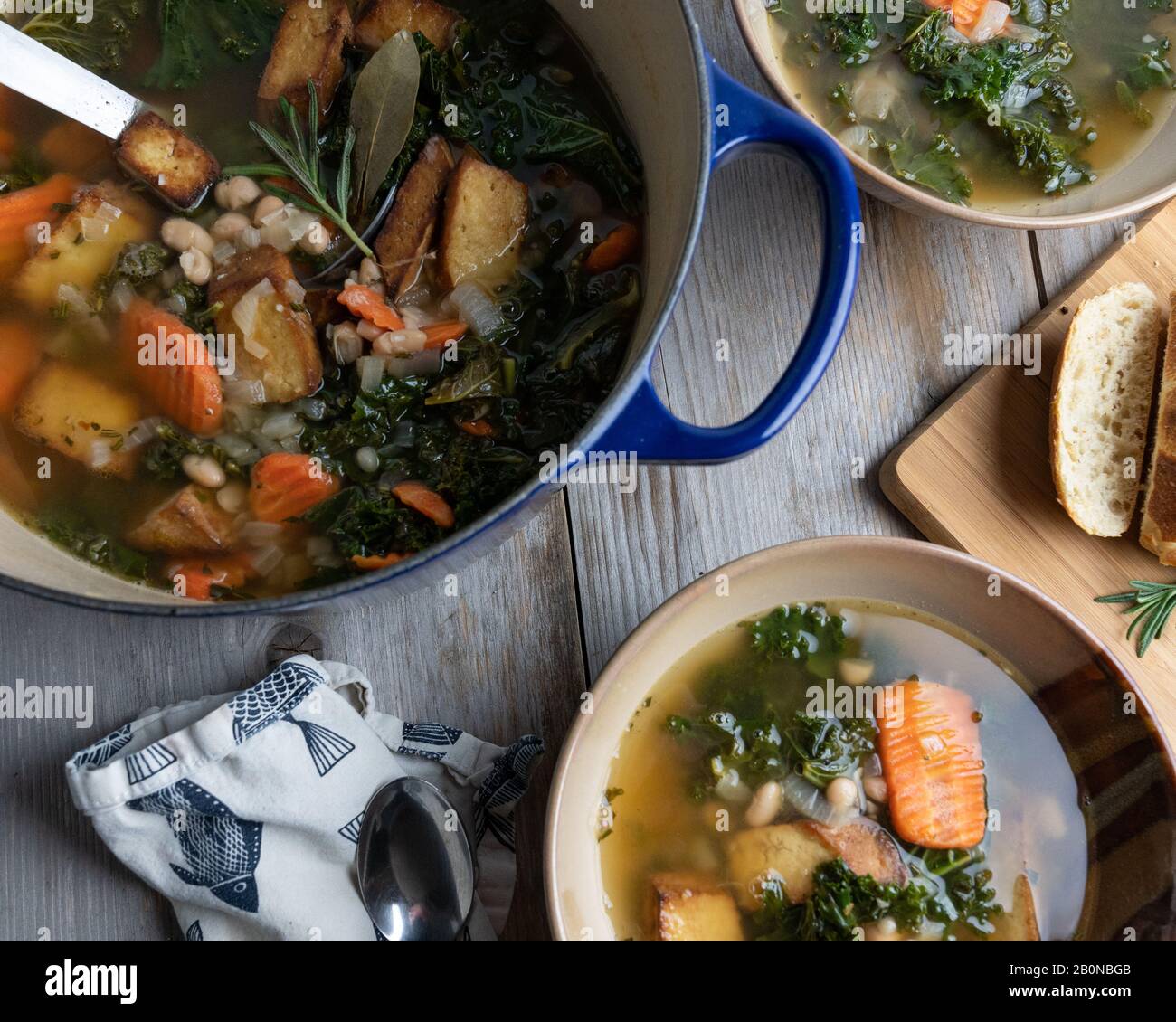 Kale and white bean soup on a rustic wood surface Stock Photo Alamy