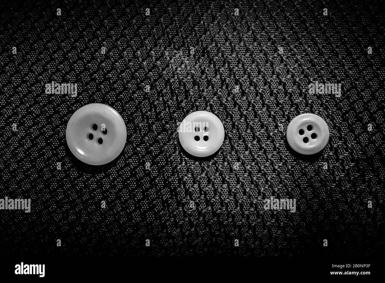abstract sewing buttons and beads on black background Stock Photo - Alamy