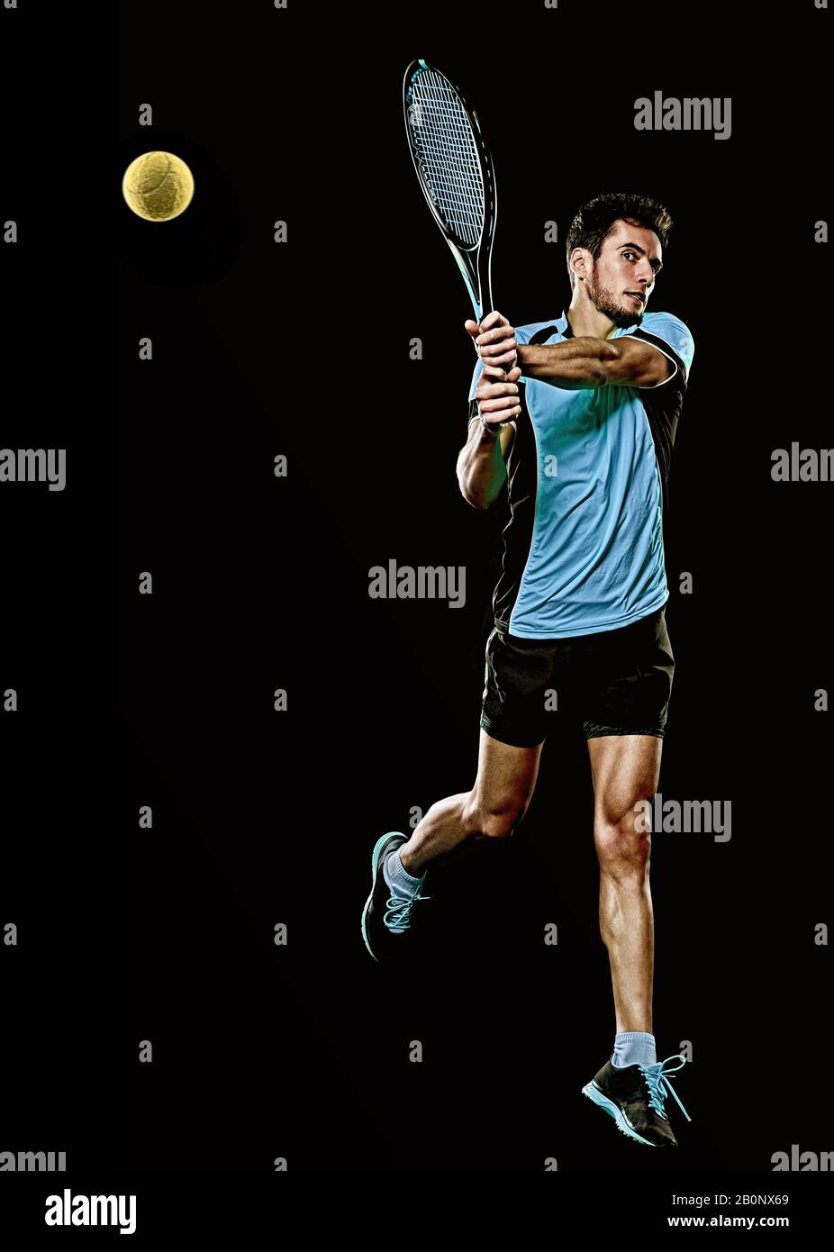 one caucasian young player tennis man in studio isolated on black background Stock Photo