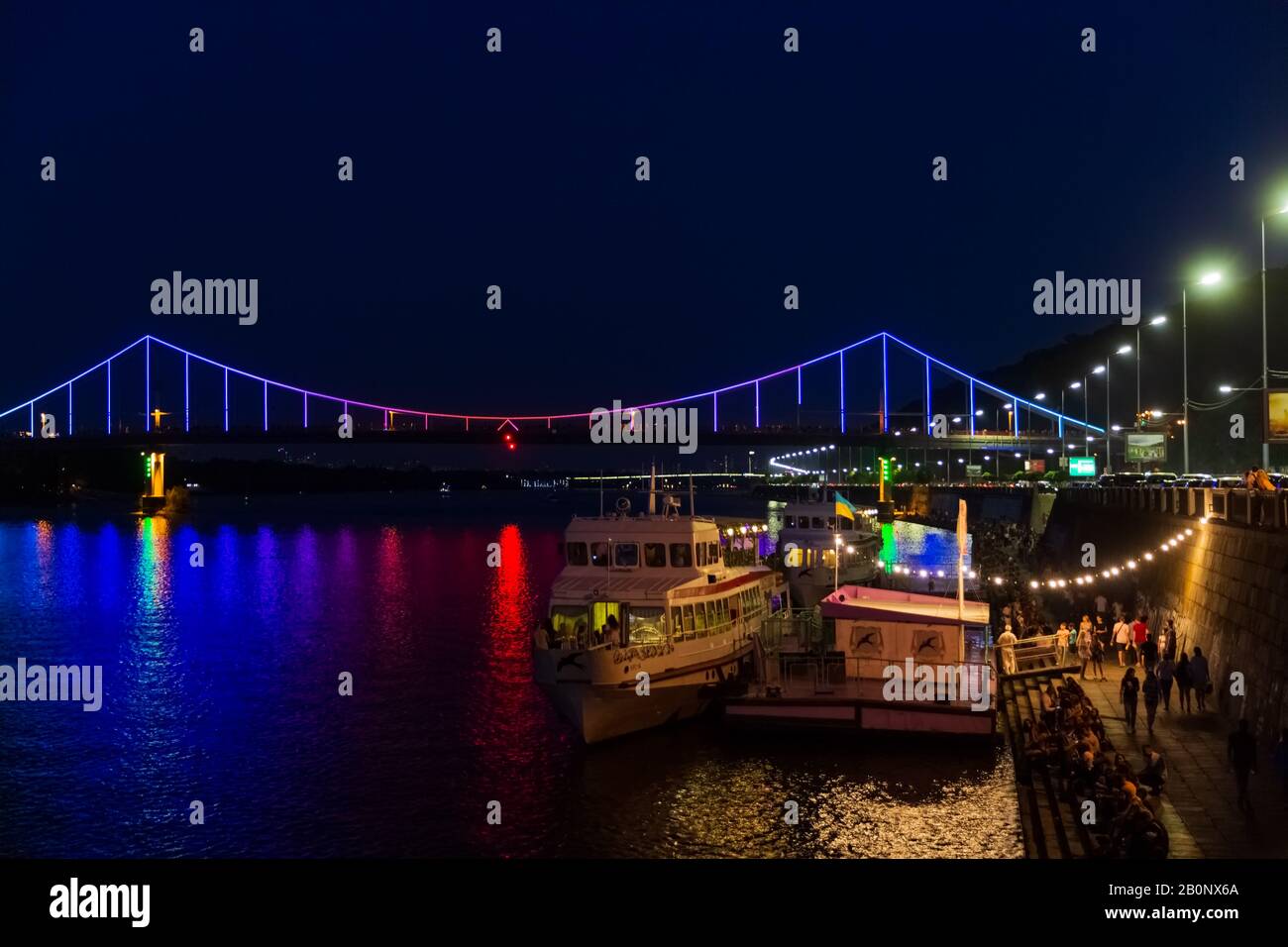 Kiev , Ukraine - August 31, 2019 : Parkovyi Bridge on Dniepr river port waterfront with cruise boats Landmark of Kiev Ukraine Europe Stock Photo