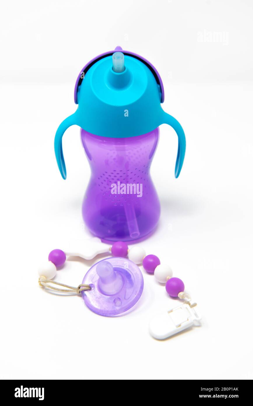 https://c8.alamy.com/comp/2B0P1AK/purple-plastic-sippy-cup-and-pacifier-on-white-background-2B0P1AK.jpg