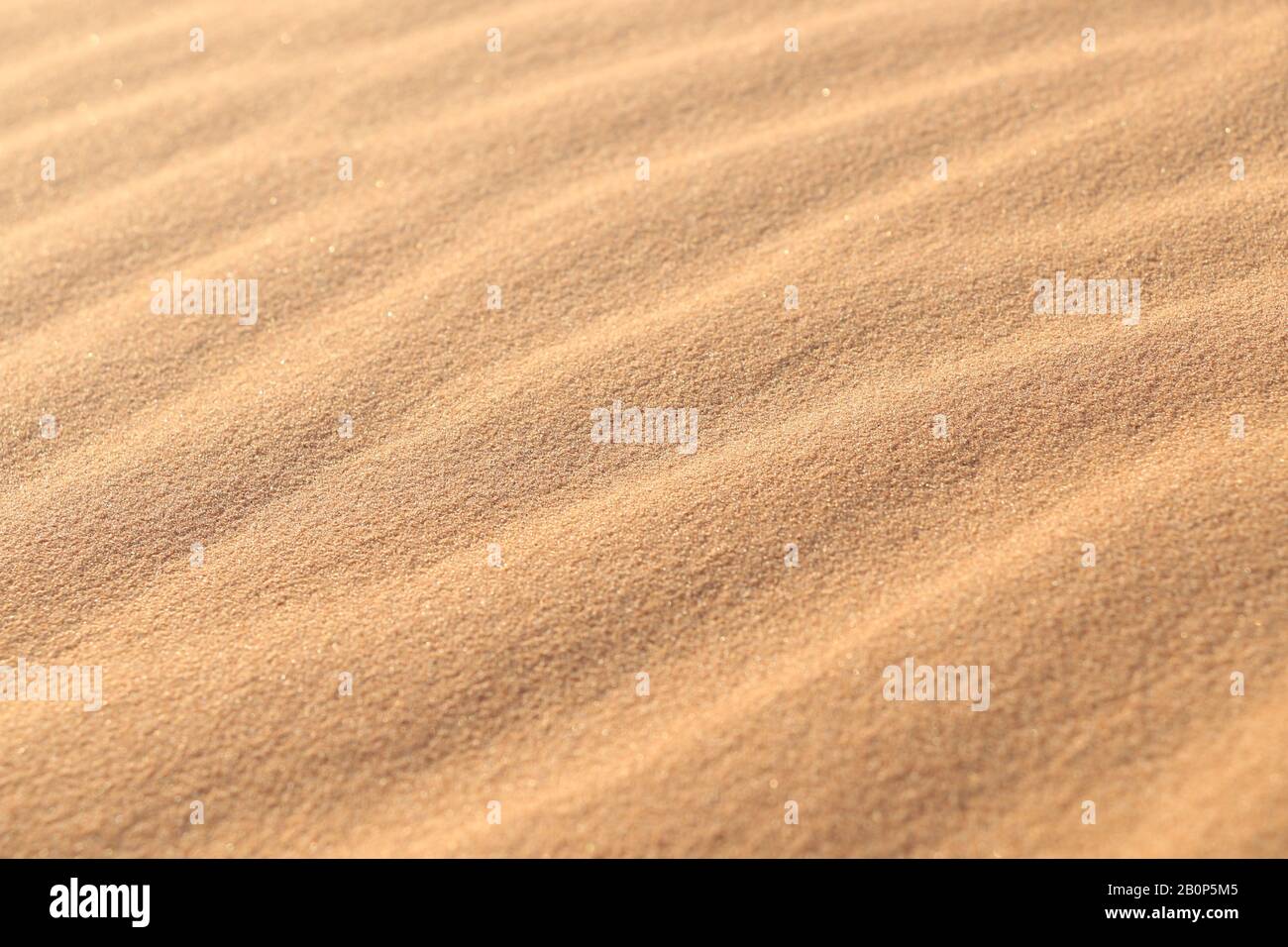 sand texture - background of desert sand dunes. Beautiful structures of sandy dunes. sand with wave from wind in desert - Close up Stock Photo