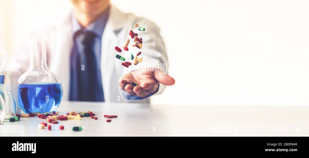 Colorful medicine pills and tablets in pharmaceutical lab. Concept of