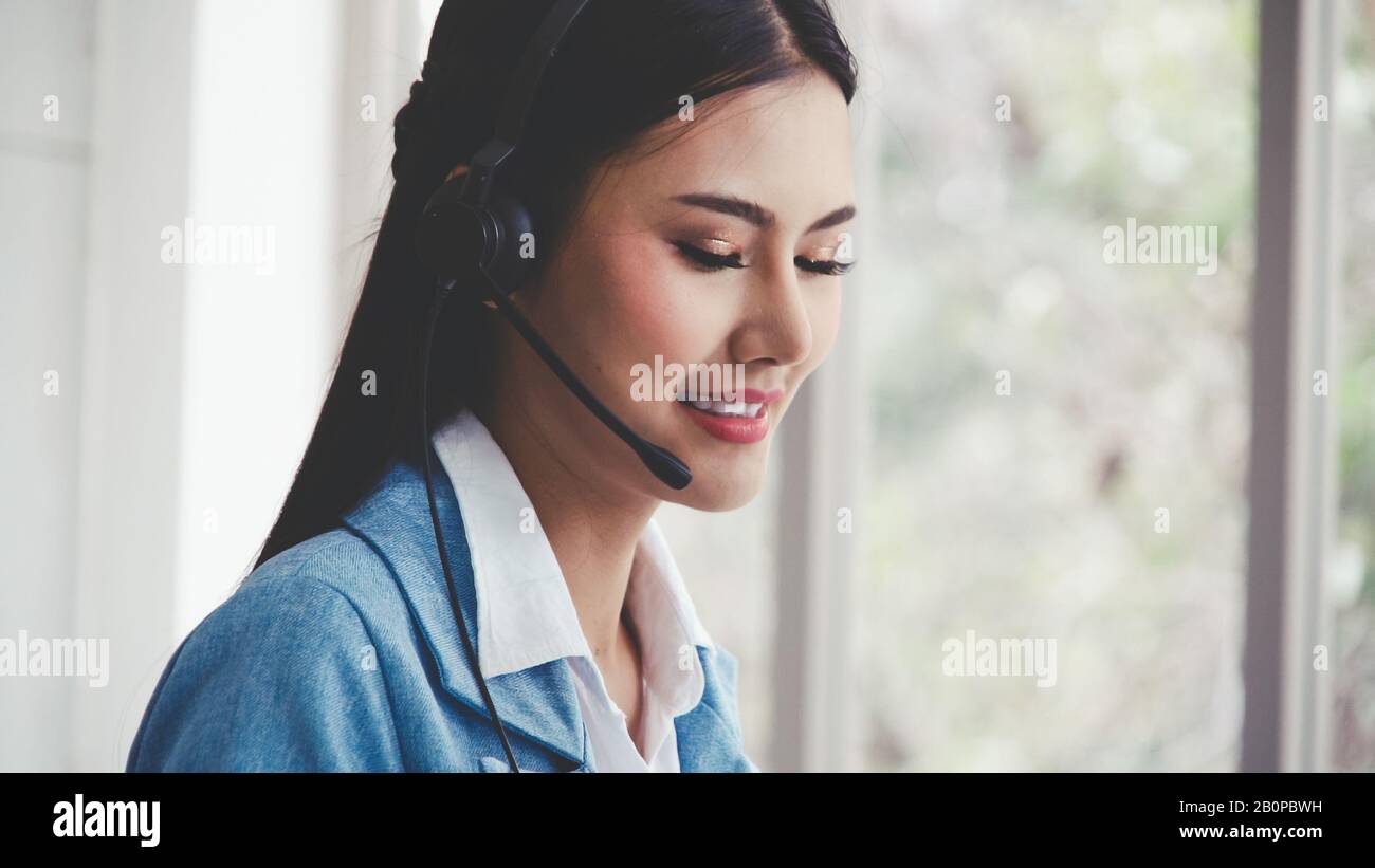 Customer support agent or call center with headset works on desktop