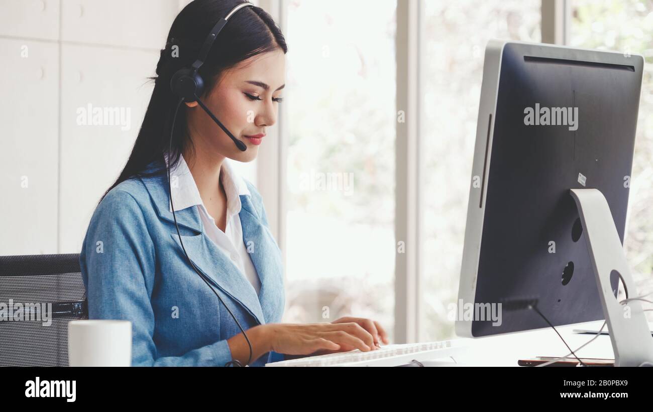 Customer support agent or call center with headset works on desktop