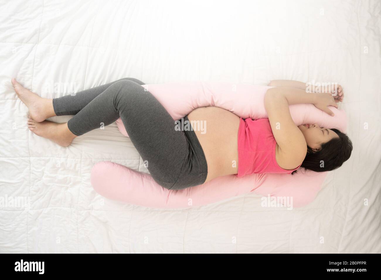 https://c8.alamy.com/comp/2B0PFPR/happy-pregnant-woman-sleeping-on-bed-in-bedroom-at-home-for-resting-and-stress-relief-the-young-expecting-mother-holding-baby-in-pregnant-belly-mate-2B0PFPR.jpg