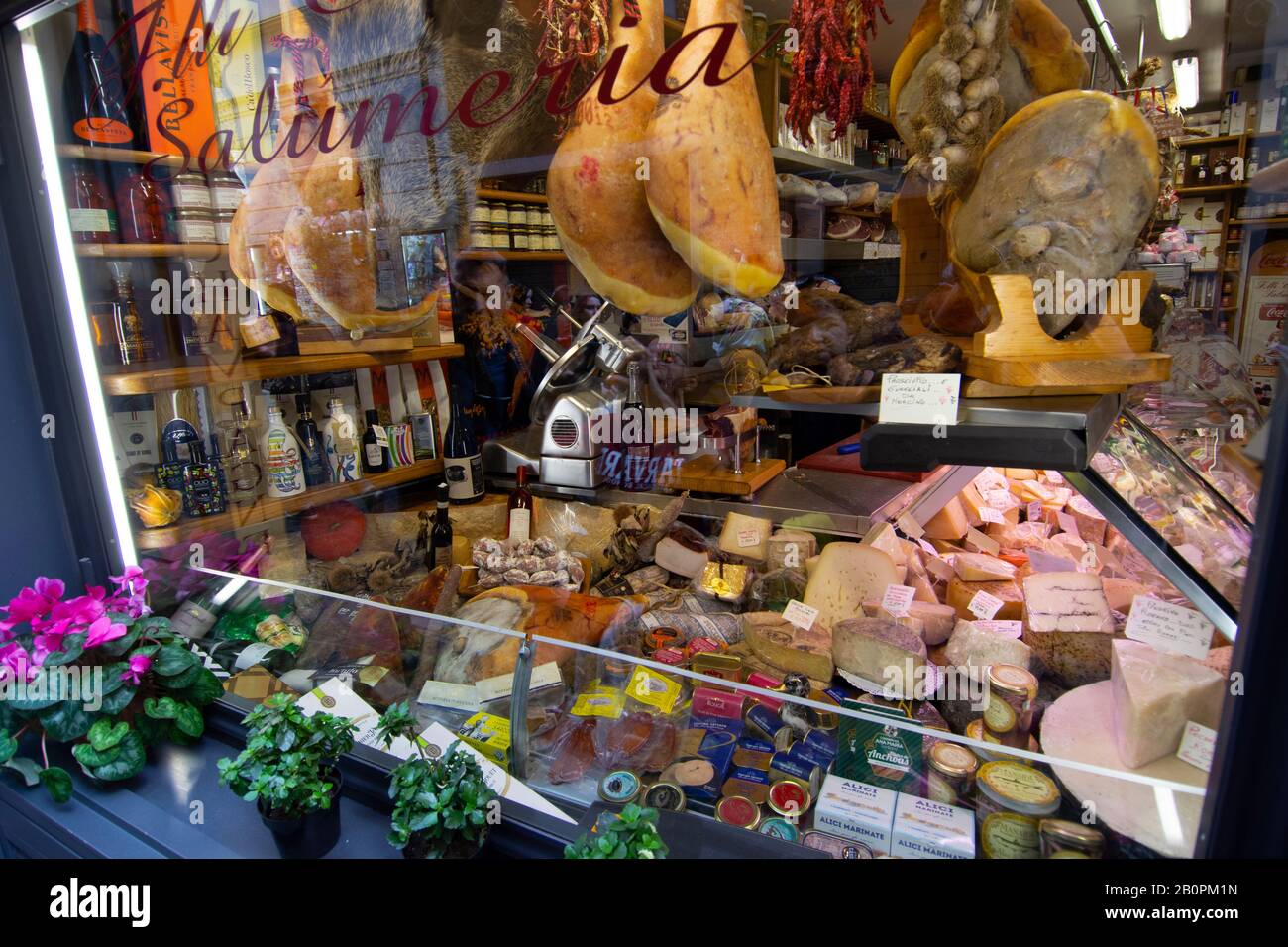 Window view of a Salumeria, shop selling charcuterie meats and cheeses, Rome, Italy Stock Photo