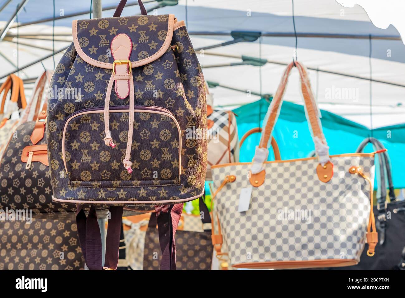 Fake highend fashion brand name famous designer purses and backpacks on  display for sale at a local outdoor flea market in Ventimiglia Italy Stock  Photo  Alamy