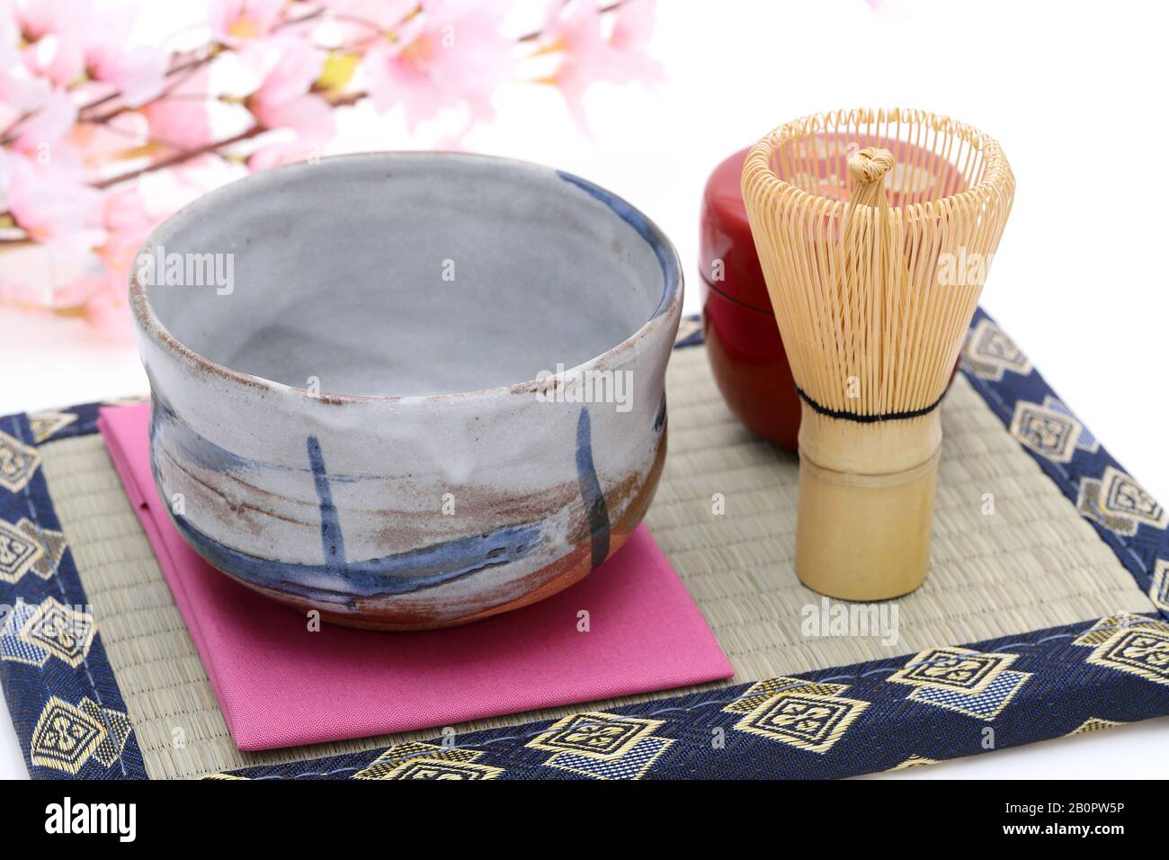 Tea bowl with tea whisk used in Japanese matcha green tea ceremony on white hackgrond Stock Photo