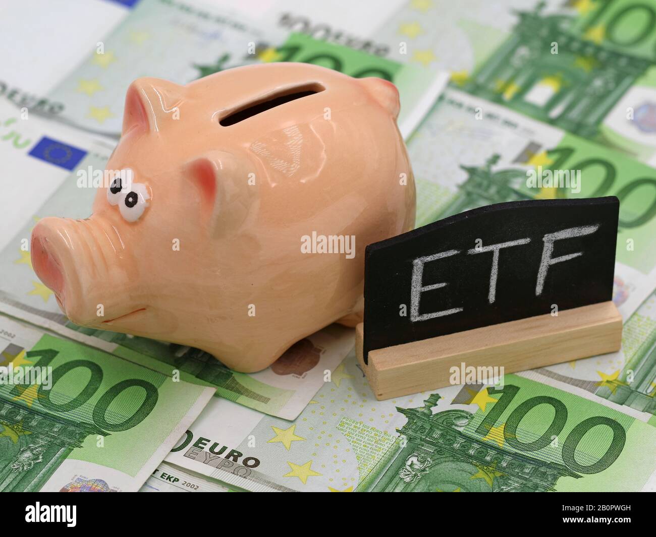 piggy bank and blackboard which shows ETF on hundred euro banknotes, concept of exchange-traded fund investment Stock Photo